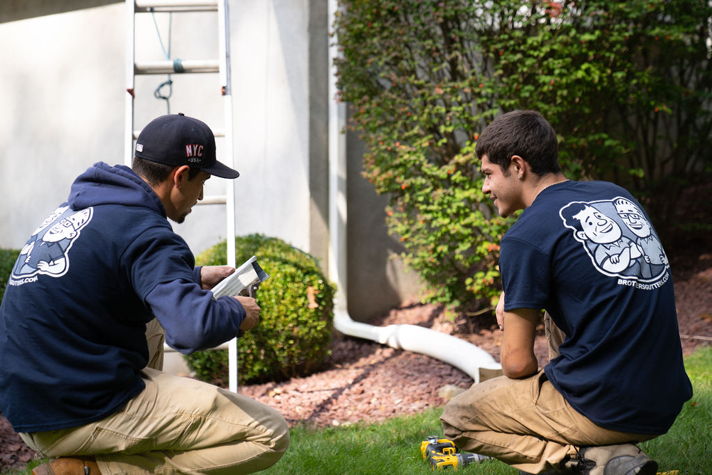 gutter contractors evaluating a gutter for repair