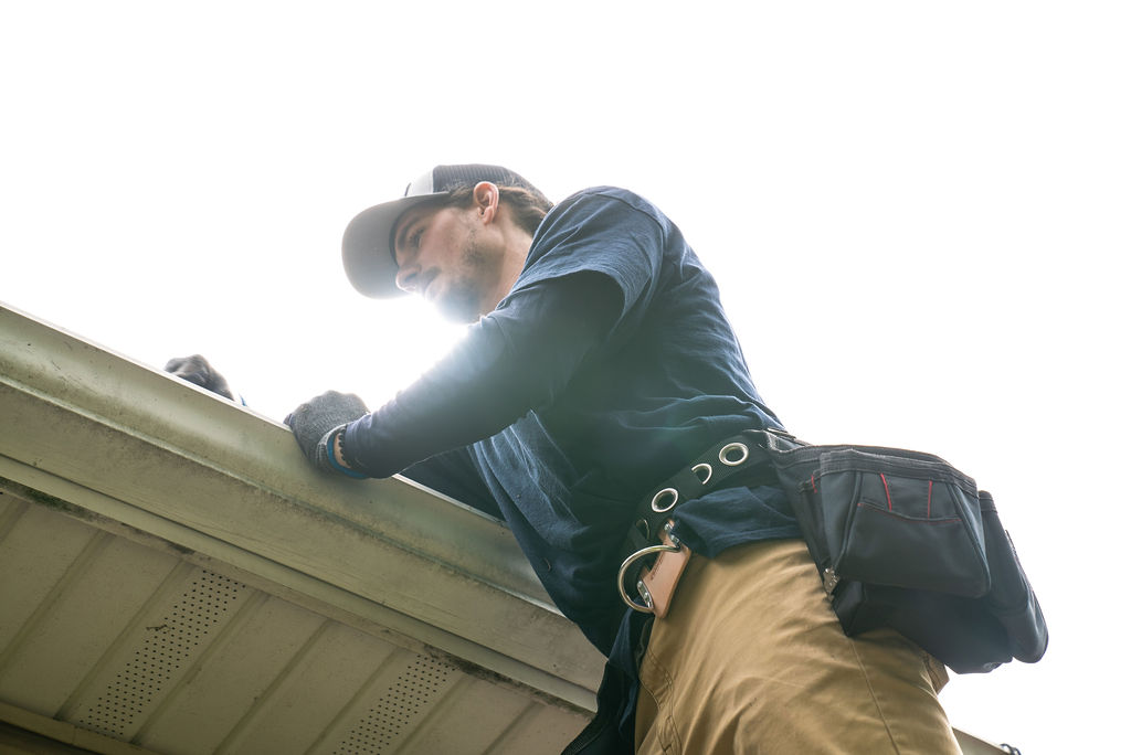 gutter tech cleaning a gutter