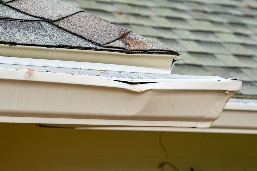 gutter repair needed - dented, sagging gutter